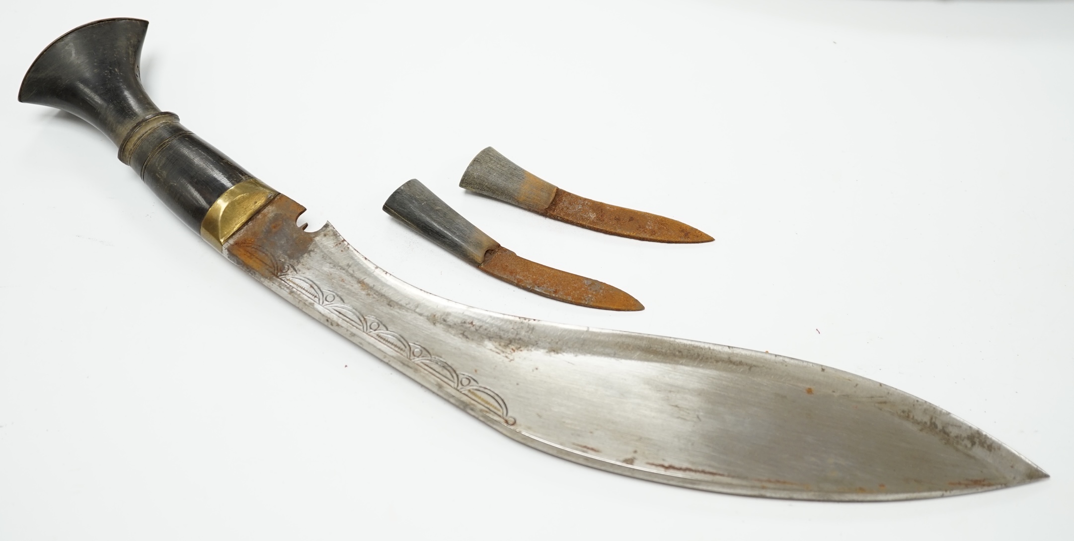 A pair of Indian Kukri, c.1950, brass mounted horn hilts, in velvet sheaths with embossed silver mounts. Condition - fair to good